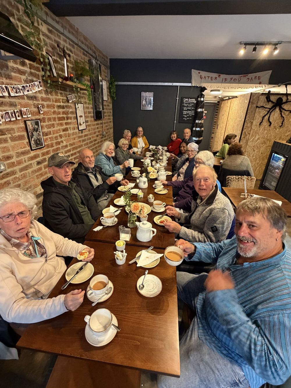 Visitors enjoying food and drinks around a table at BALANCE