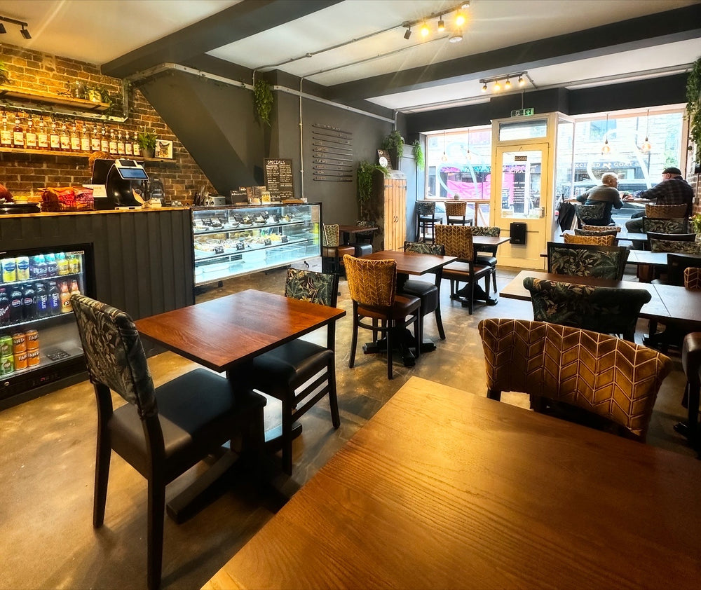 Inside BALANCE café in Hebden Bridge, with wooden tables and colourful seating