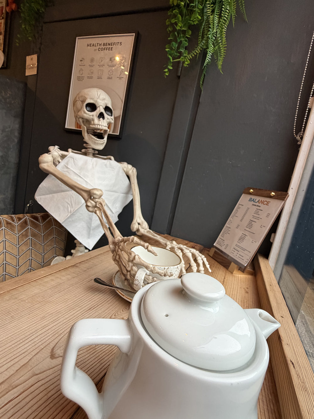 A playful skeleton display beside a coffee at BALANCE