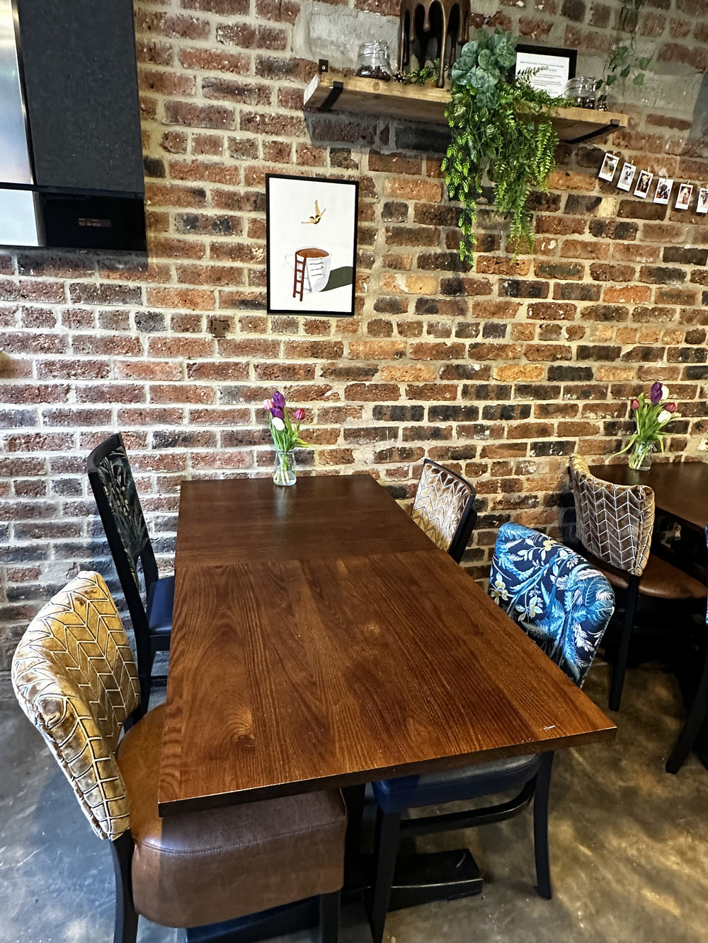 A cosy table against the exposed brick wall at BALANCE
